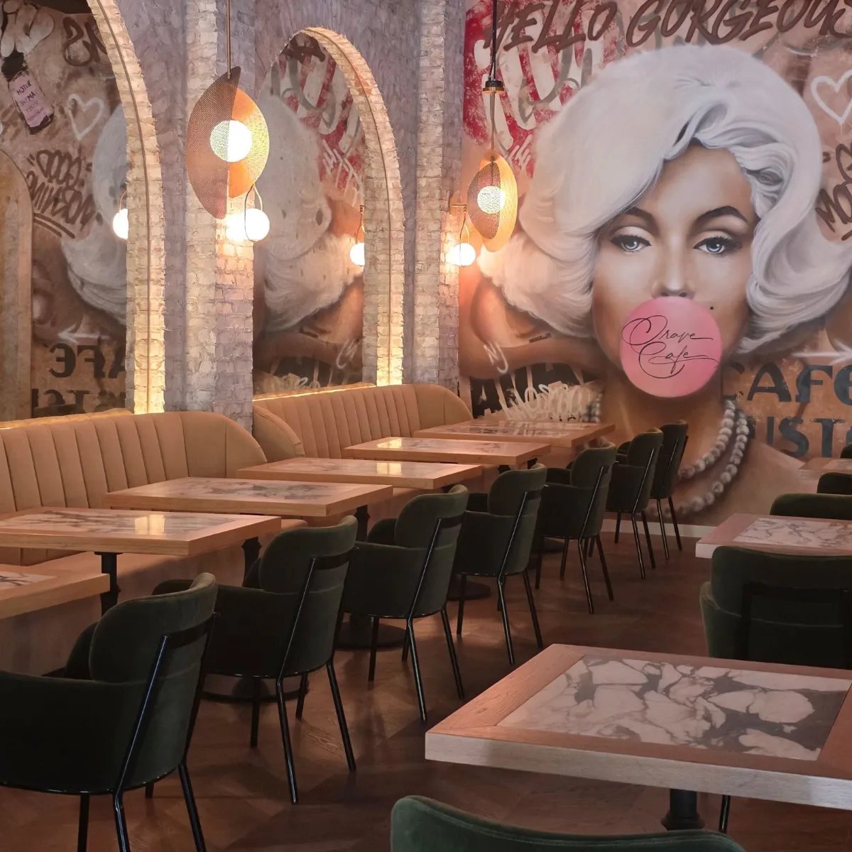 Banquette seating beneath the mural wall at Crave Café