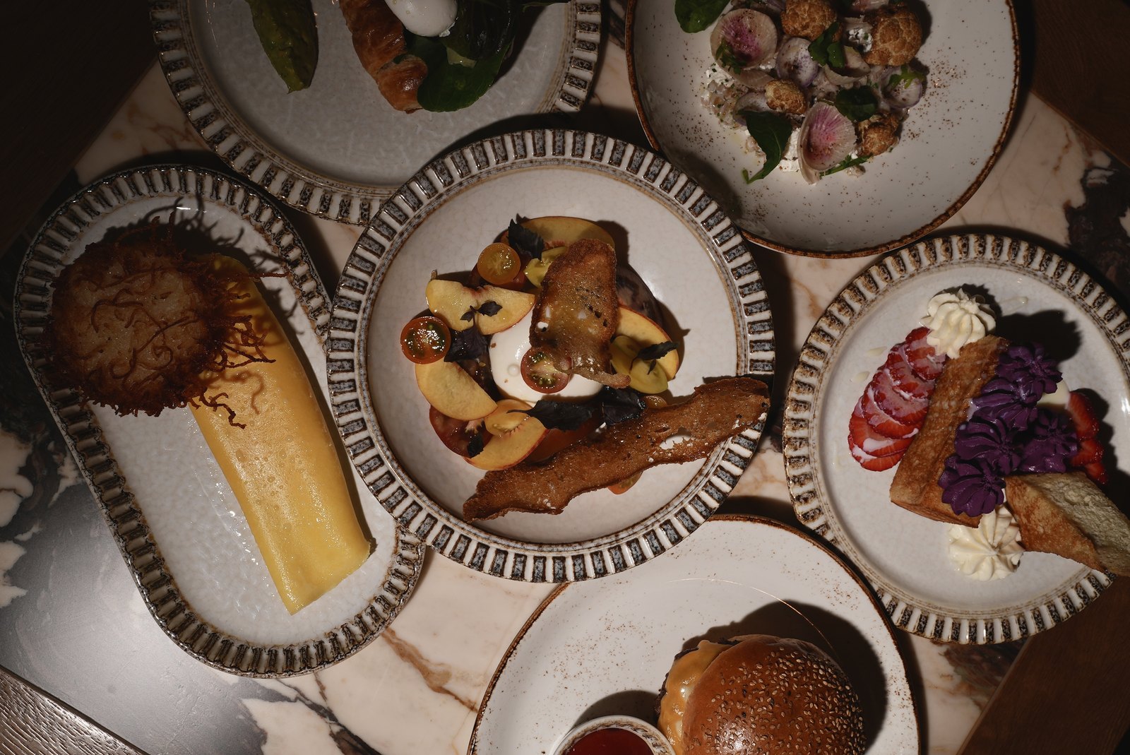 Overhead view of brunch plates on a marble table at Crave Café